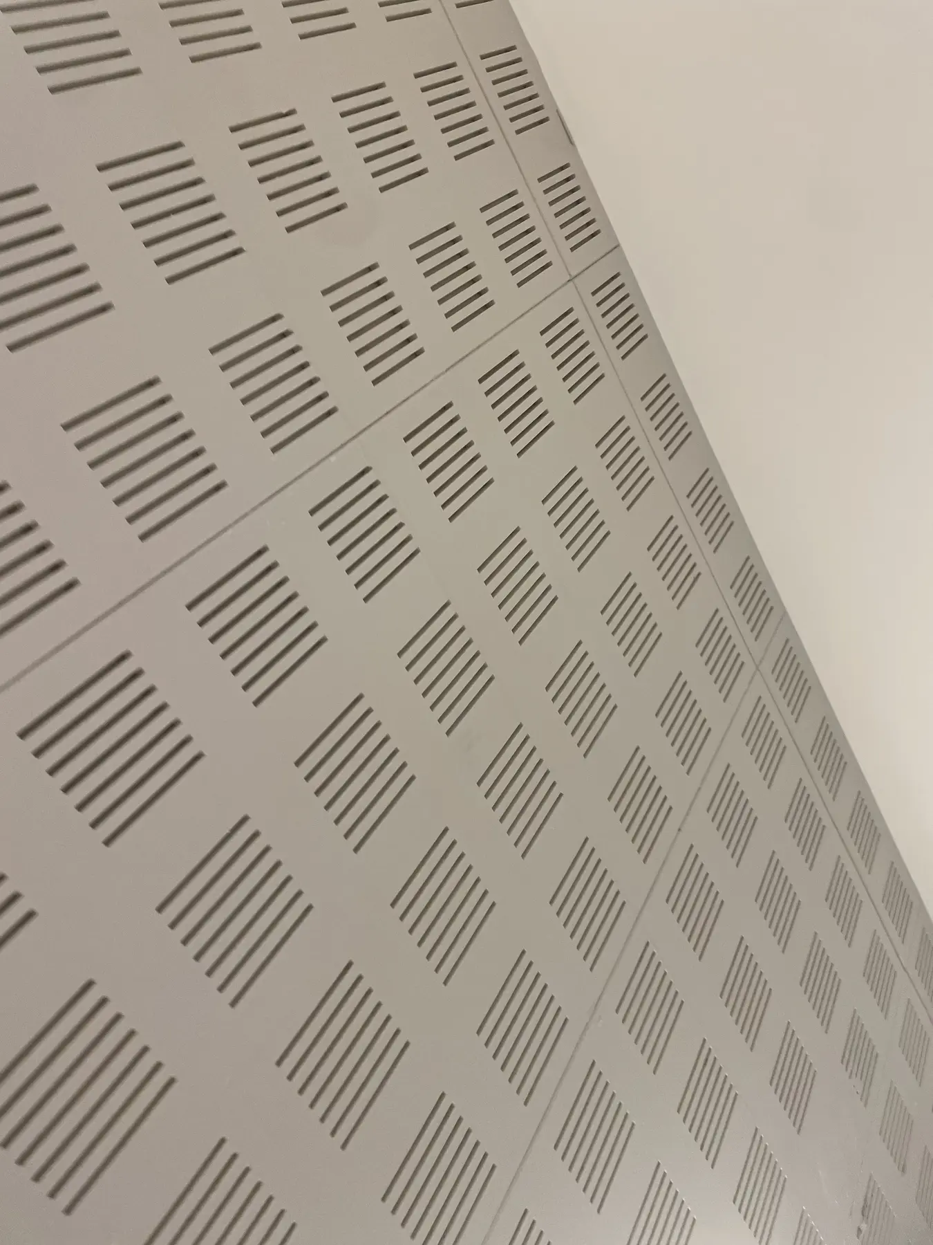 Perforated acoustic panels in an occupied building